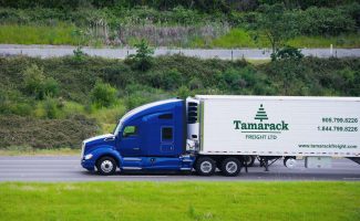 Blue Semi Truck hauling for Tamarack Trucking
